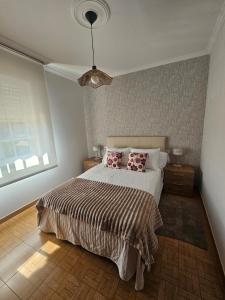 a bedroom with a bed with two pillows on it at Casa A devesa in Cangas de Morrazo
