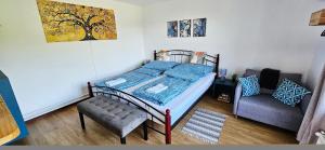 a bedroom with a bed and a chair in it at Oscar Apartman Rezi in Rezi