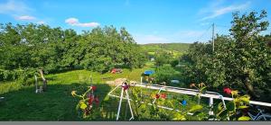 a group of people in a field with trees at Oscar Apartman Rezi in Rezi