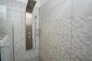 a bathroom with a shower with a glass door at More Garden in Opric +29 photos