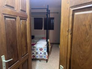 a small bedroom with a bed and a small door at Villa Farou in Mbour