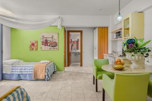 a bedroom with a bed and a table and chairs at Golden Bay Apartments-Garden Haven in Malia +68 photos