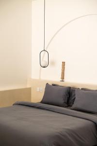 a bedroom with a bed with a light above it at Villa Papì Uluwatu 1 in Bingin Beach