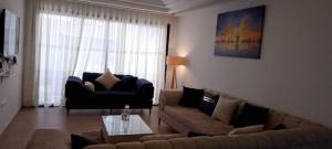 a living room with a couch and a coffee table at Kelibia Jinen EL mansoura in Kelibia