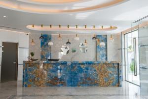 a lobby with a blue counter and pendant lights at Kalithea Horizon Blu - Adults Only in Kallithea Rhodes