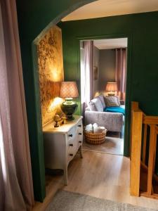 a living room with a bed and a table with a lamp at Escapade en Alsace - gîte de charme pour deux à Bergheim in Bergheim