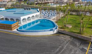 a large swimming pool in front of a building at Kalithea Horizon Blu - Adults Only in Kallithea Rhodes