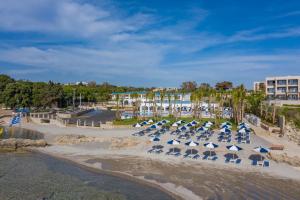 a group of chairs and umbrellas on a beach at Kalithea Horizon Blu - Adults Only in Kallithea Rhodes