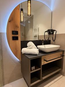 a bathroom with a sink and a mirror at Alpen Relais in Fondo