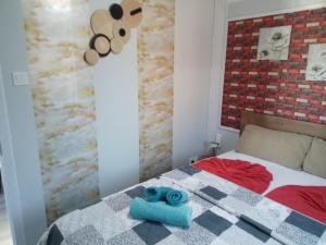 a bedroom with a bed with blue towels on it at Mountain View Bungalows Dimilia in Fánai +75 photos