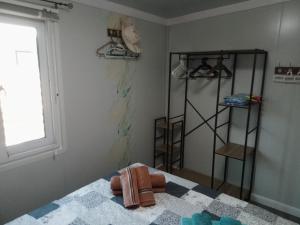 a bedroom with a bed with a towel on it at Mountain View Bungalows Dimilia in Fánai