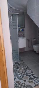 a bathroom with a glass shower and a sink at Kelibia Jinen EL mansoura in Kelibia