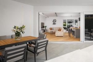 a dining room and living room with a table and chairs at Residence Maru' in Rovinj