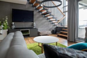a living room with a couch and a tv at ApartView Premium by Rent like home in Wisła +17 photos