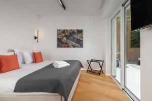 a bedroom with a bed and a large window at Residence Maru' in Rovinj +25 photos