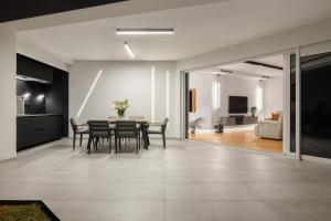 a dining room and living room with a table and chairs at Residence Maru' in Rovinj