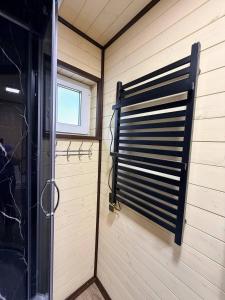 a shower in a room with a window and a door at Подих Свободи in Sloboda