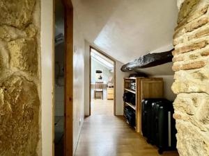 a room with a hallway with a stone wall at Bluedothotels location France in Magnac-Laval