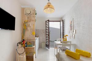 a living room with a couch and a table at O Sole Mio Zen Haven in Valras-Plage