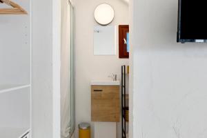 a white bathroom with a sink and a mirror at O Sole Mio Zen Haven in Valras-Plage +11 photos