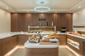 a kitchen with a table with a basket of bread at Solimar Topaz - Adults Only in Tavronitis