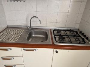 a kitchen with a sink and a stove at Villamareblu in Ventimiglia +208 photos