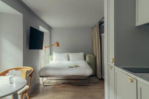 a bedroom with a bed and a table at Eden Locke in Edinburgh