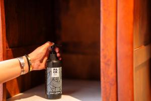 a person is holding a lighter in a bottle at Indulge McLeodganj by Pack in McLeod Ganj