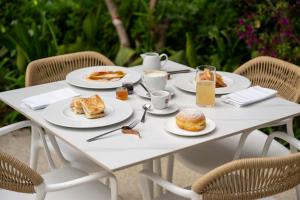 a white table with plates of food on it at Villa Verdeoro in Montesilvano