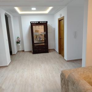 a living room with a couch and a cabinet at Kelibia Jinen EL mansoura in Kelibia +1 photo