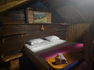 a bedroom with a bed in a wooden room at My Olive Garden Camp in Bar