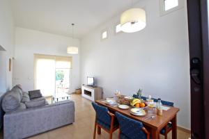 a living room with a table and a couch at Casa Morera by Rental Olé in Torre-Pacheco