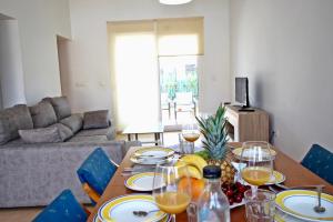 a dining room table with plates and wine glasses on it at Casa Morera by Rental Olé in Torre-Pacheco