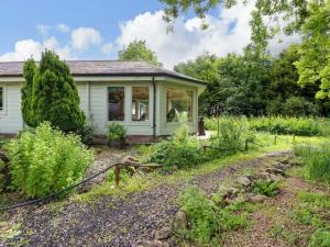 a house with a garden in front of it at Bulrush Cabin in Carlisle