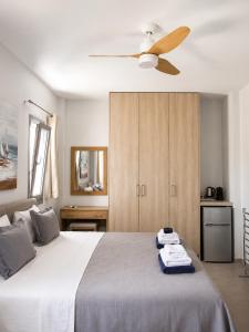 a bedroom with a bed with a ceiling fan at Blue Sea Paros Aegean Horizon in Drios