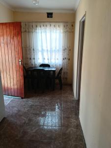 a dining room with a table and a window at Phezulu Air B & B in Richards Bay