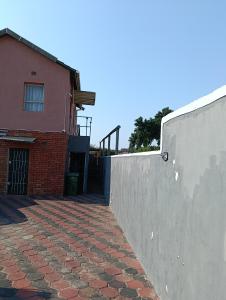 a brick retaining wall next to a building at Phezulu Air B & B in Richards Bay