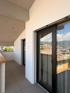 a balcony of a building with a view of the ocean at Alpen Relais in Fondo