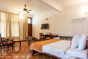 a bedroom with a bed and a living room at By The Bay Kovalam in Trivandrum