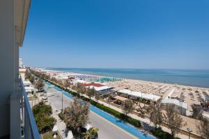 a view of a beach and the ocean from a building at Hotel Continental in Senigallia