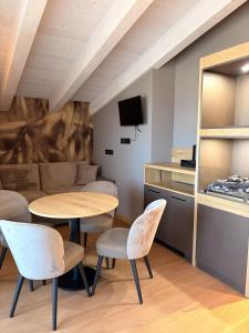 a room with a table and chairs and a couch at Alpen Relais in Fondo +17 photos