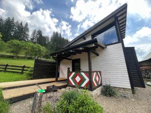a small house with a large window on it at Fazenda Fishbone, будиночок White fish in Verkhovyna