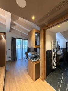 a room with a kitchen with a stove top oven at Alpen Relais in Fondo