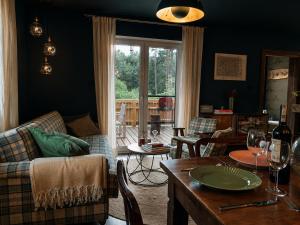 a living room with a couch and a table at Sosnowy Taras in Koszele