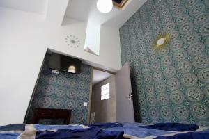 a bedroom with a bed and a blue wall at LA VILLA DU CAP in Cap-Ferret
