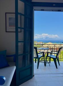 a door leading to a balcony with a table and chairs at LITHARI PENTHOUSE in Alikanas +57 photos