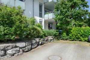 a stone retaining wall in front of a house at Ferienwohnung Annabelle in Bodman-Ludwigshafen