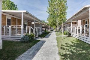 a walkway leading up to a row of cottages at Camping Adria Riccione in Riccione