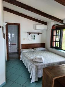 a bedroom with a large bed and a bathroom at Appartamenti Salato in Tropea +185 photos