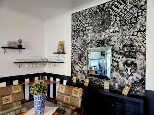 a room with a mirror on a wall at Villa Mexicana Guesthouse in Kimberley